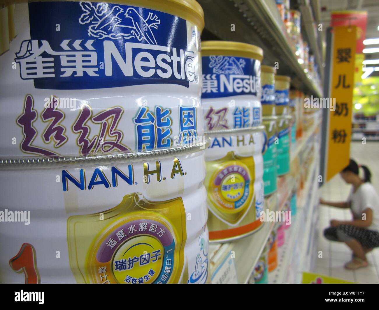 --FILE--Tins of Nestle milk powder are for sale at a supermarket in Nantong city, east China's Jiangsu province, 19 August 2013.   Swiss firm Nestle, Stock Photo