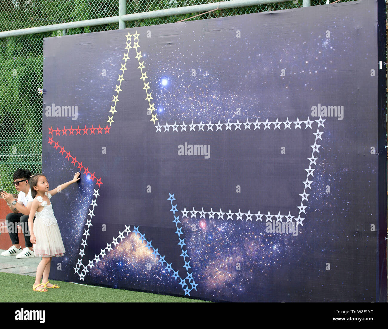 The star-shaped sign of a government-sponsored campaign that calls for civilized driving is pictured during a private car flash mob event in Shenzhen Stock Photo