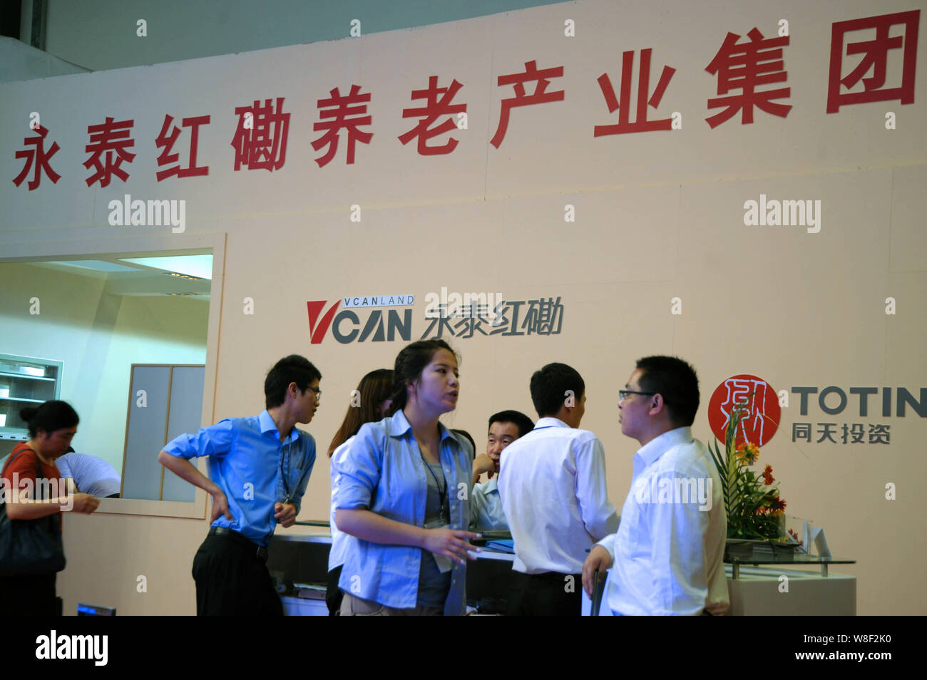 --FILE--People visit the stand of Vcanland during a fair in Shanghai, China, 18 May 2012.    Vcanland Holdings Group is spearheading a search for a na Stock Photo
