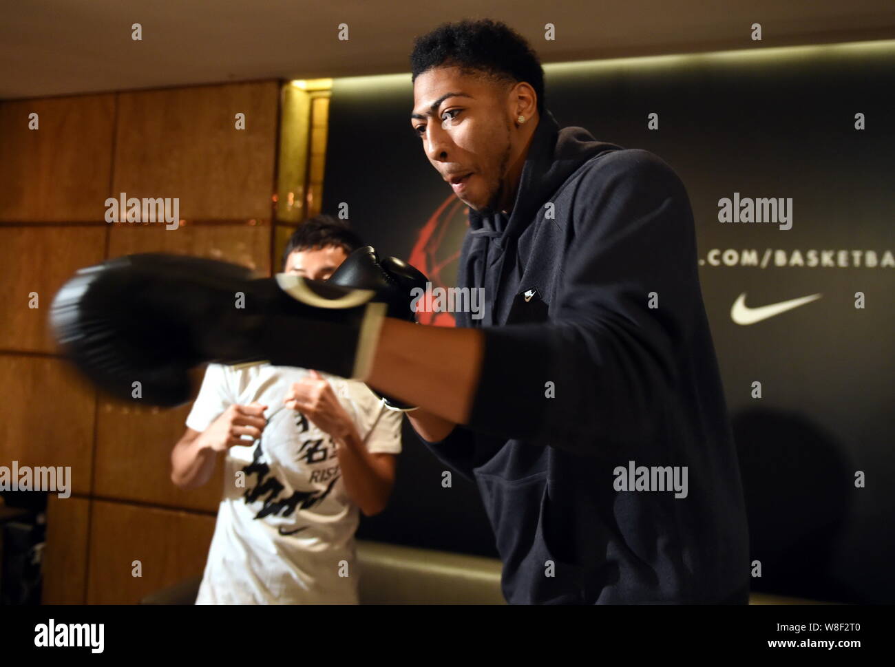 NBA star Anthony Davis wearing boxing gloves learns boxing at a media