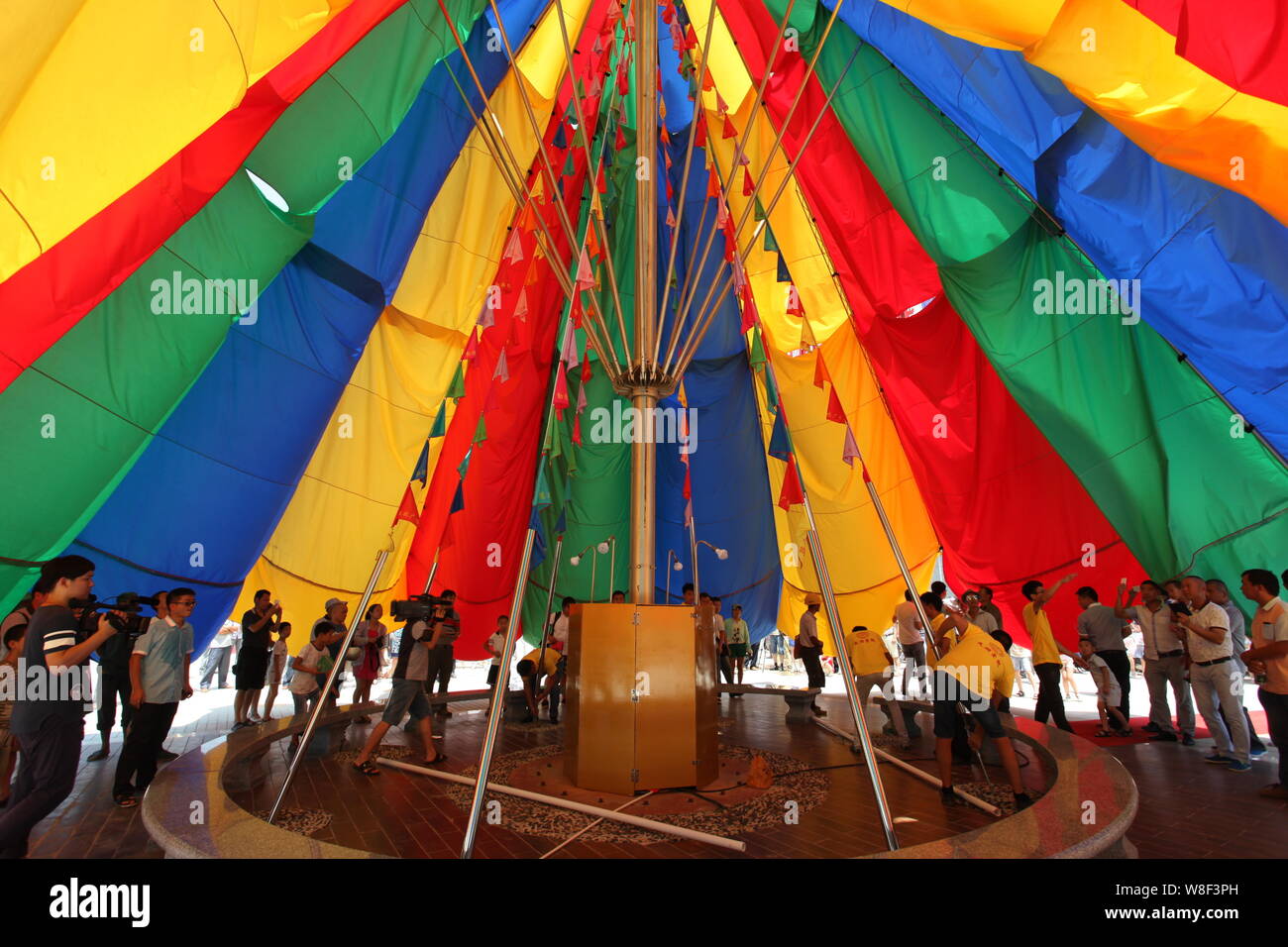 People stand under the world's biggest umbrella after it was certified