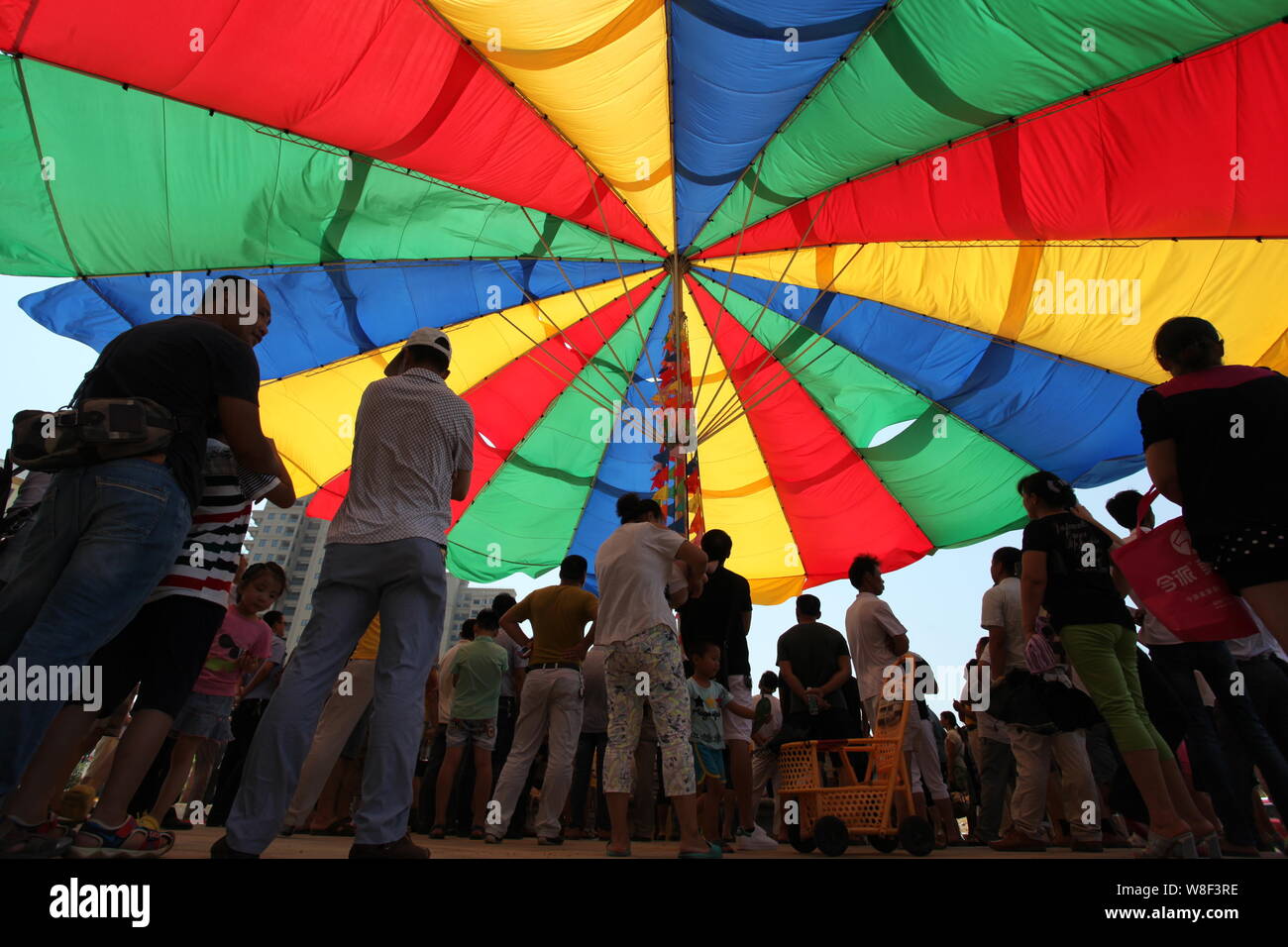 People stand under the world's biggest umbrella after it was certified