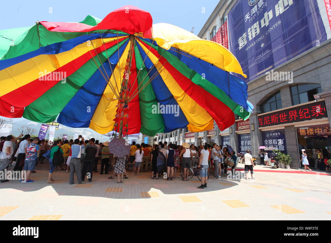 People stand under the world's biggest umbrella after it was certified