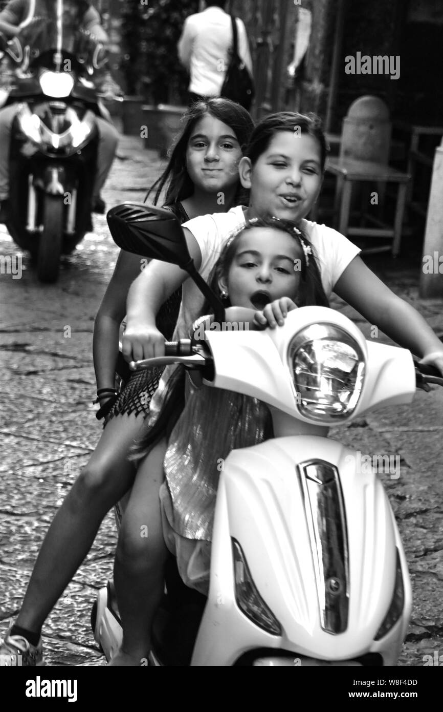 Joyride, Three Girls on one Scooter, Spanish Quarter, Naples, Italy Stock Photo
