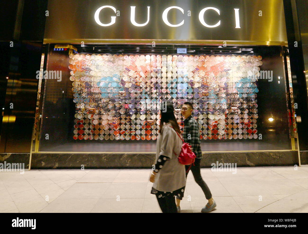 FILE--Pedestrians walk past the fashion boutique of Gucci at Galaxy Mall in  Tianjin, China, 27 March 2015. Alibaba Group Holding Ltd., China's lar  Stock Photo - Alamy