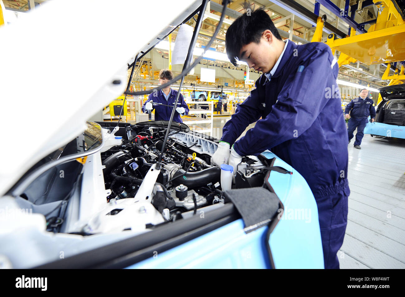Chinese workers assemble a Ford SUV on the assembly line at the auto ...