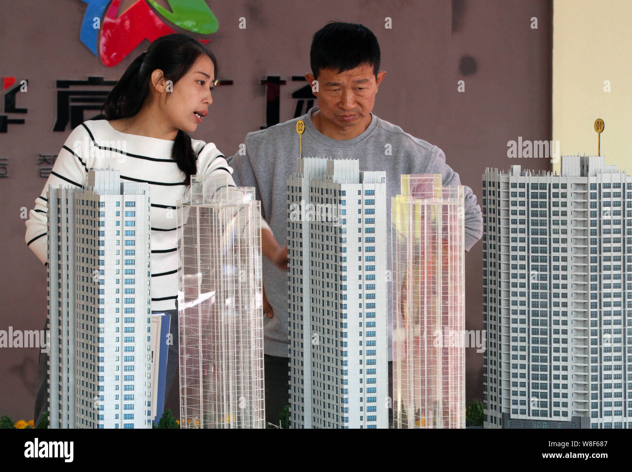 --FILE--Chinese homebuyers look at housing models of a residential property project at a real estate fair in Huai'an city, east China's Jiangsu provin Stock Photo