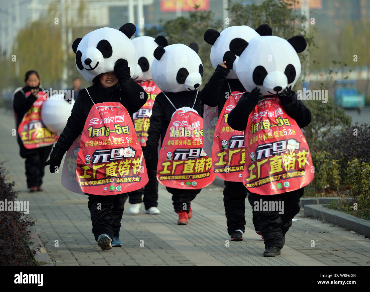 Chinese promoters of a merchant dressed in panda costumes in the street to welcome New Year in Xuancheng city, east China's Anhui province, 29 Decembe Stock Photo