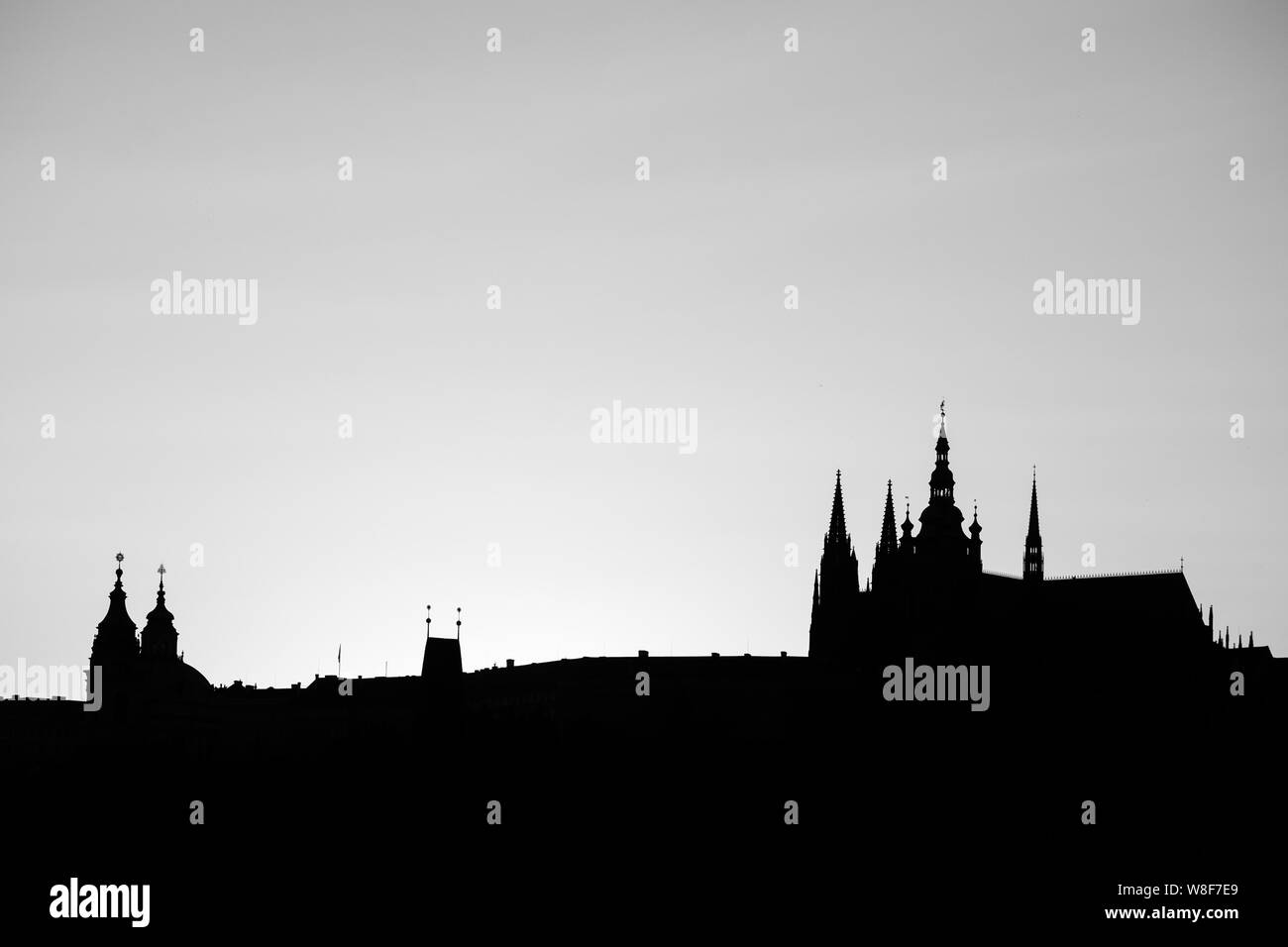 Silhouette at sunset of St. Vitus cathedral against the setting Sun from Prague, Czech Republic Stock Photo