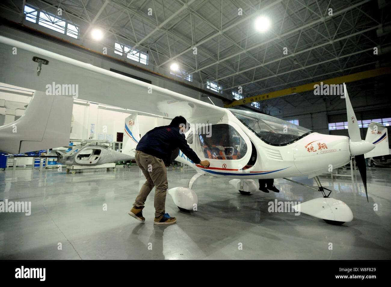 A Chinese worker checks the door of China's first domestically ...