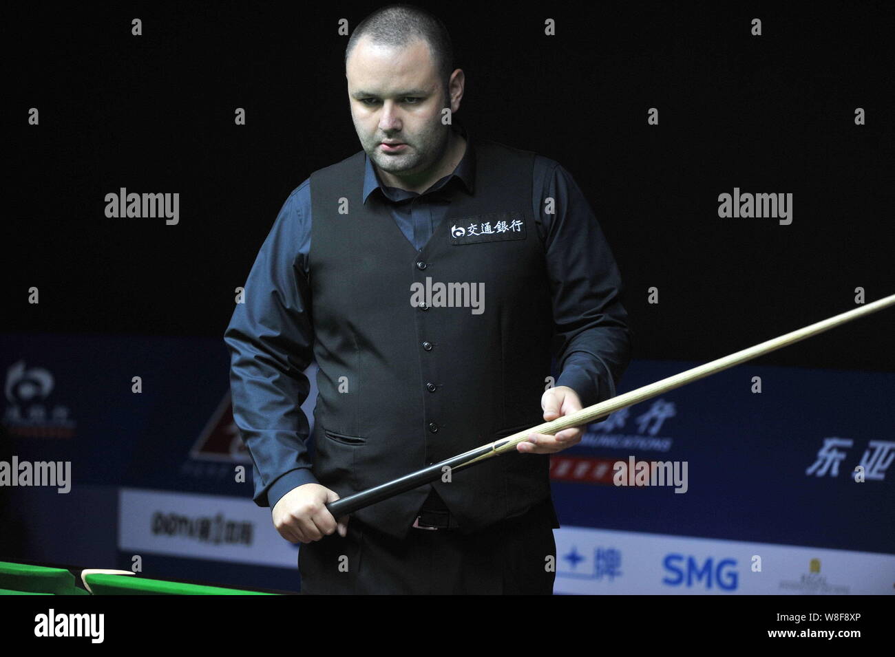 Stephen Maguire of England considers a shot against Michael Holt of England during their first round match of the 2015 World Snooker Shanghai Masters Stock Photo