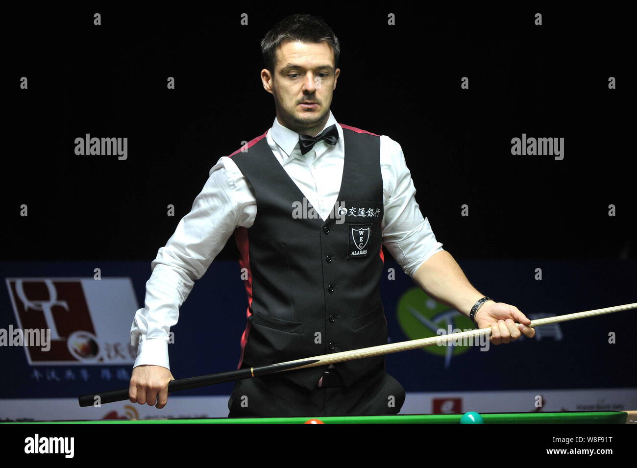 Michael Holt of England considers a shot against Stephen Maguire of England during their first round match of the 2015 World Snooker Shanghai Masters Stock Photo