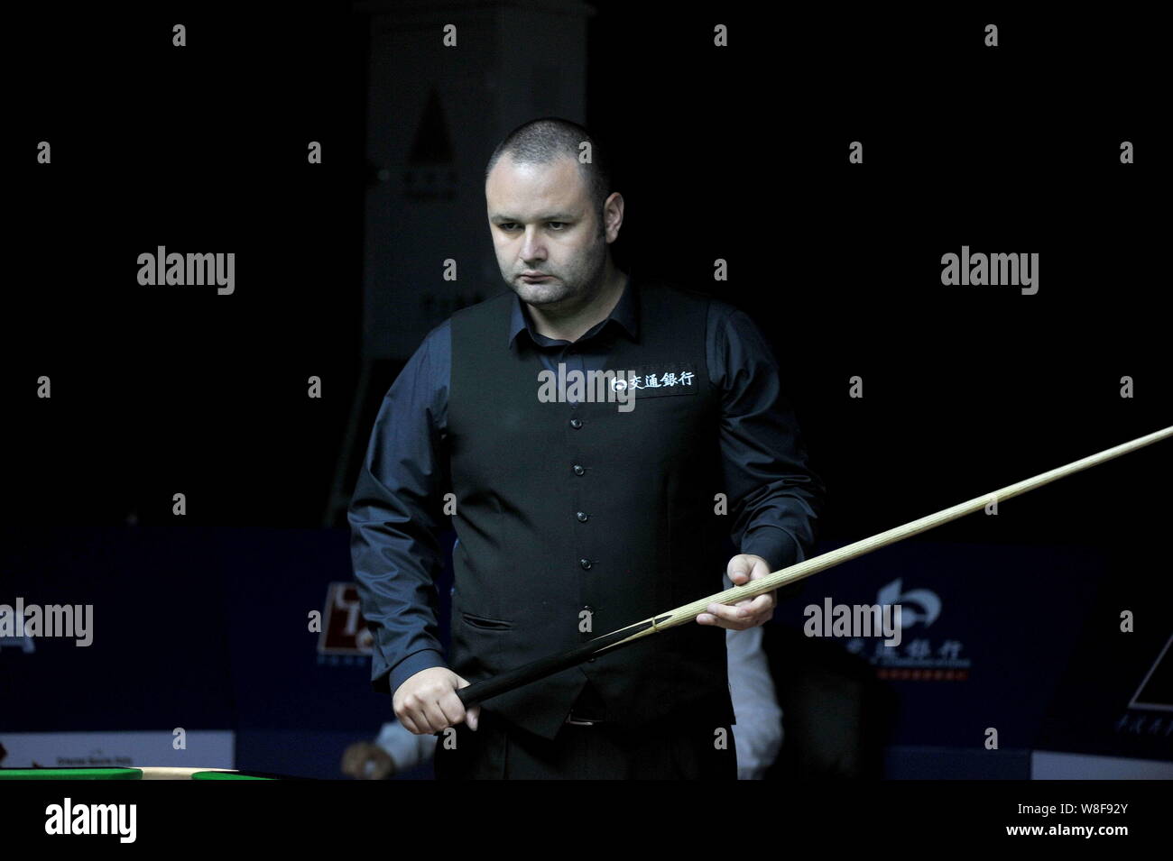 Stephen Maguire of England considers a shot against Michael Holt of England during their first round match of the 2015 World Snooker Shanghai Masters Stock Photo