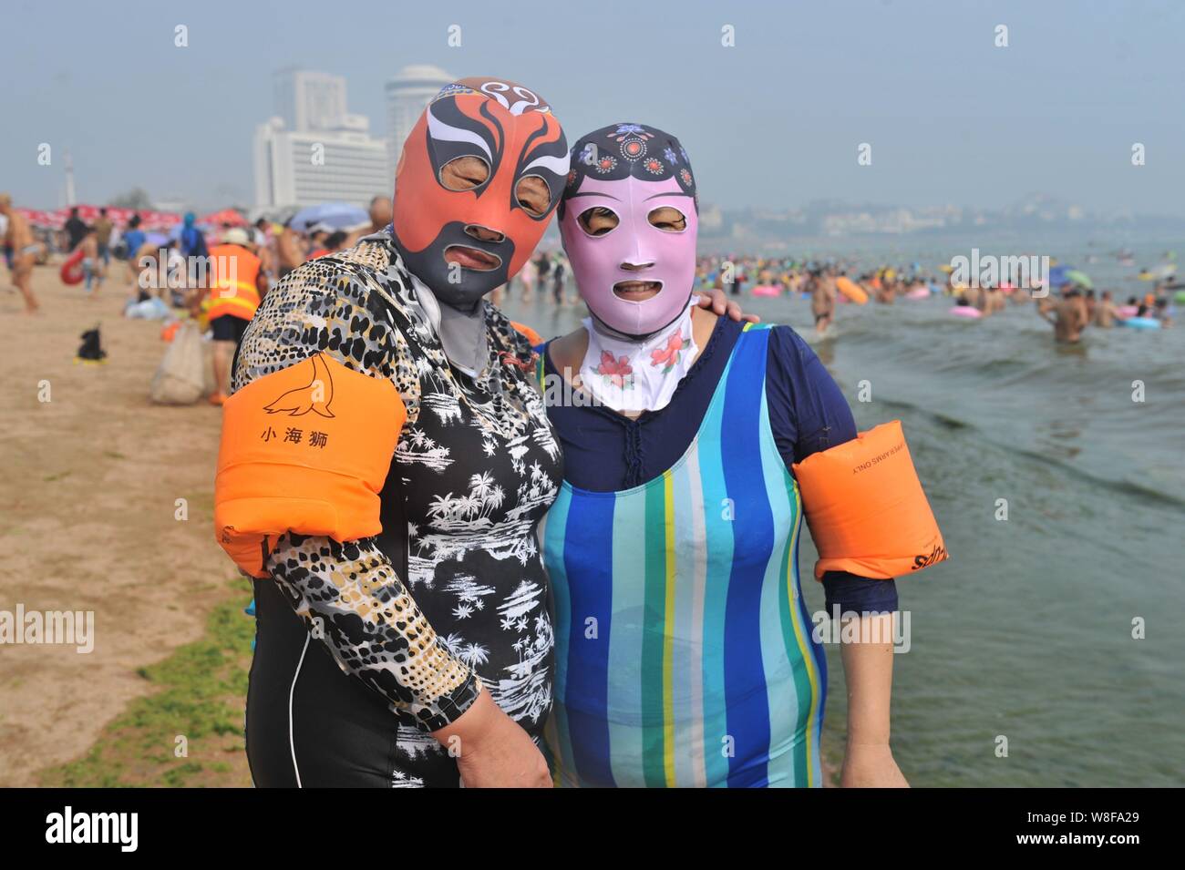 by drivhus ubehag Female Chinese swimmers wearing facekinis featuring designs of traditional  Peking Opera pose at a beach resort in Qingdao city, east China's Shandong  Stock Photo - Alamy