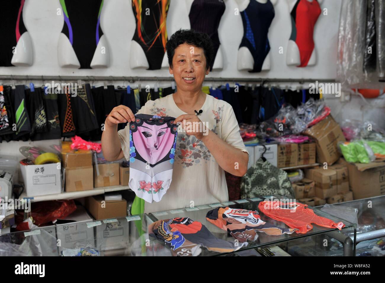 Chinese facekini designer Zhang Shifan shows a facekini mask featuring