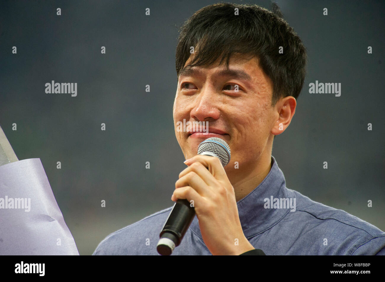 Chinese hurdler Liu Xiang smiles during his retirement ceremony at the ...