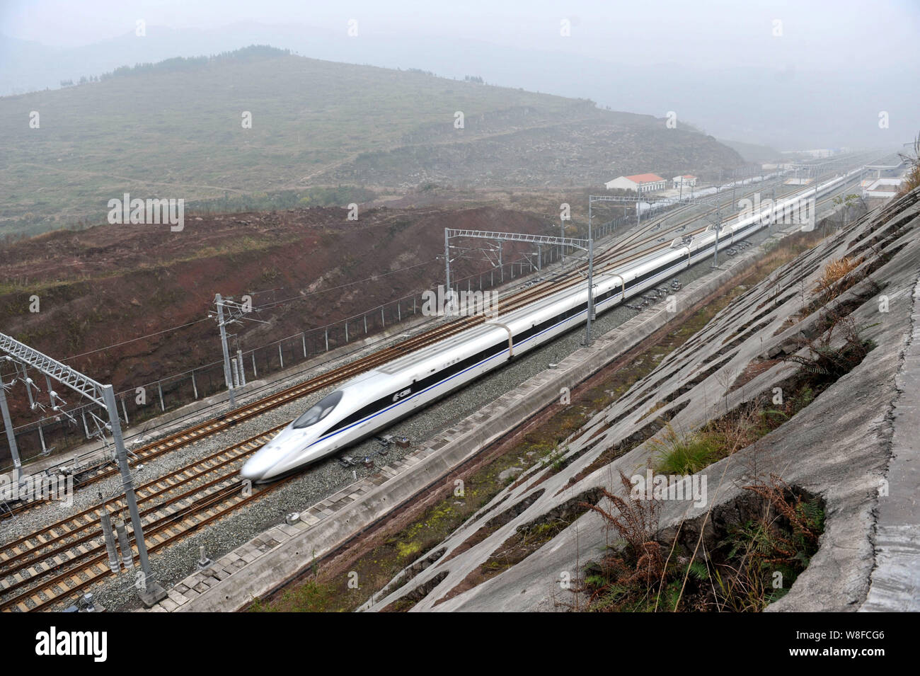 --FILE--A CRH (China Railway High-speed) bullet train travels on the Yuli (Chengdu-Beijing) High-speed Railway in Chongqing, China, 1 January 2015. Stock Photo