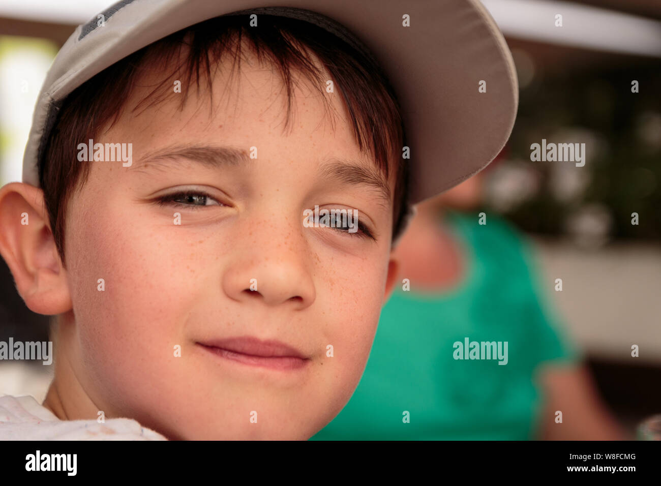 portrait-of-a-cute-little-8-year-old-boy-outdoors-wearing-a-gray