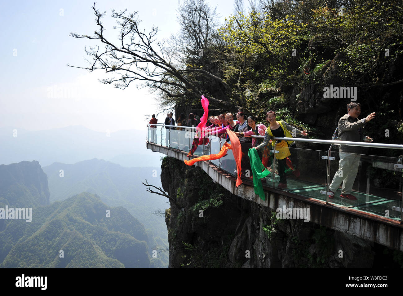 Tourists Walk On The Glass Skywalk On The Cliff Of Tianmen Mountain Or Tianmenshan Mountain In Zhangjiajie National Forest Park In Zhangjiajie City Stock Photo Alamy