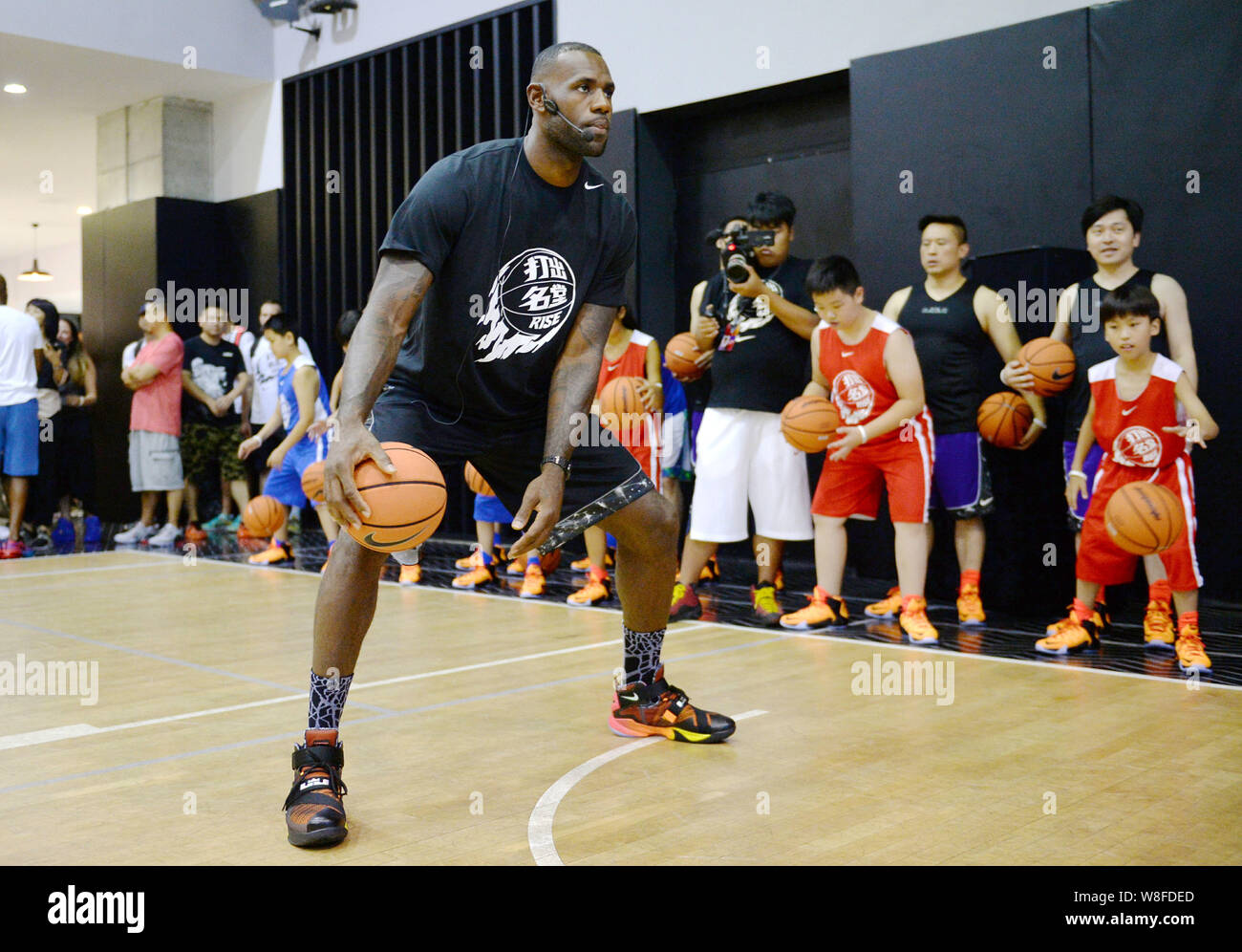 NBA star LeBron James, front, instructs young Chinese kids and other  participants in playing basketball at a campus event by Nike in Shanghai,  China Stock Photo - Alamy