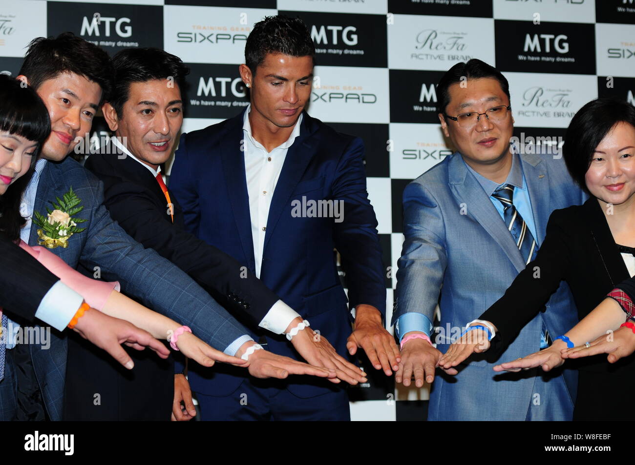 Portuguese football superstar Cristiano Ronaldo, center, poses during a promotional event for MTG Training Gear Sixpad fitness equipment in Shanghai, Stock Photo