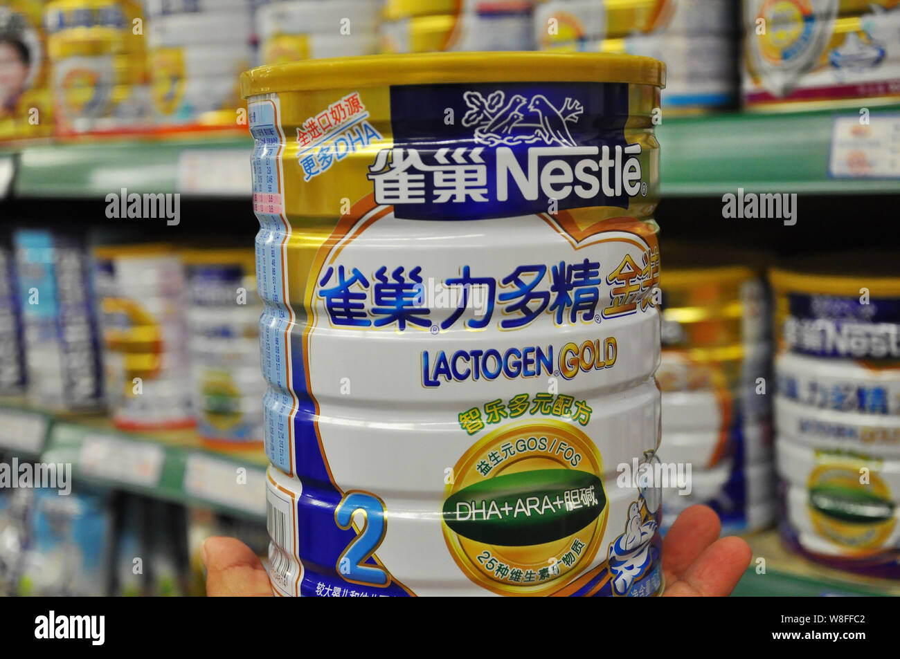 --FILE--A customer shops for a tin of Nestle infant formula at a supermarket in Rizhao city, central China's Shandong province, 7 May 2014.   Nestle S Stock Photo