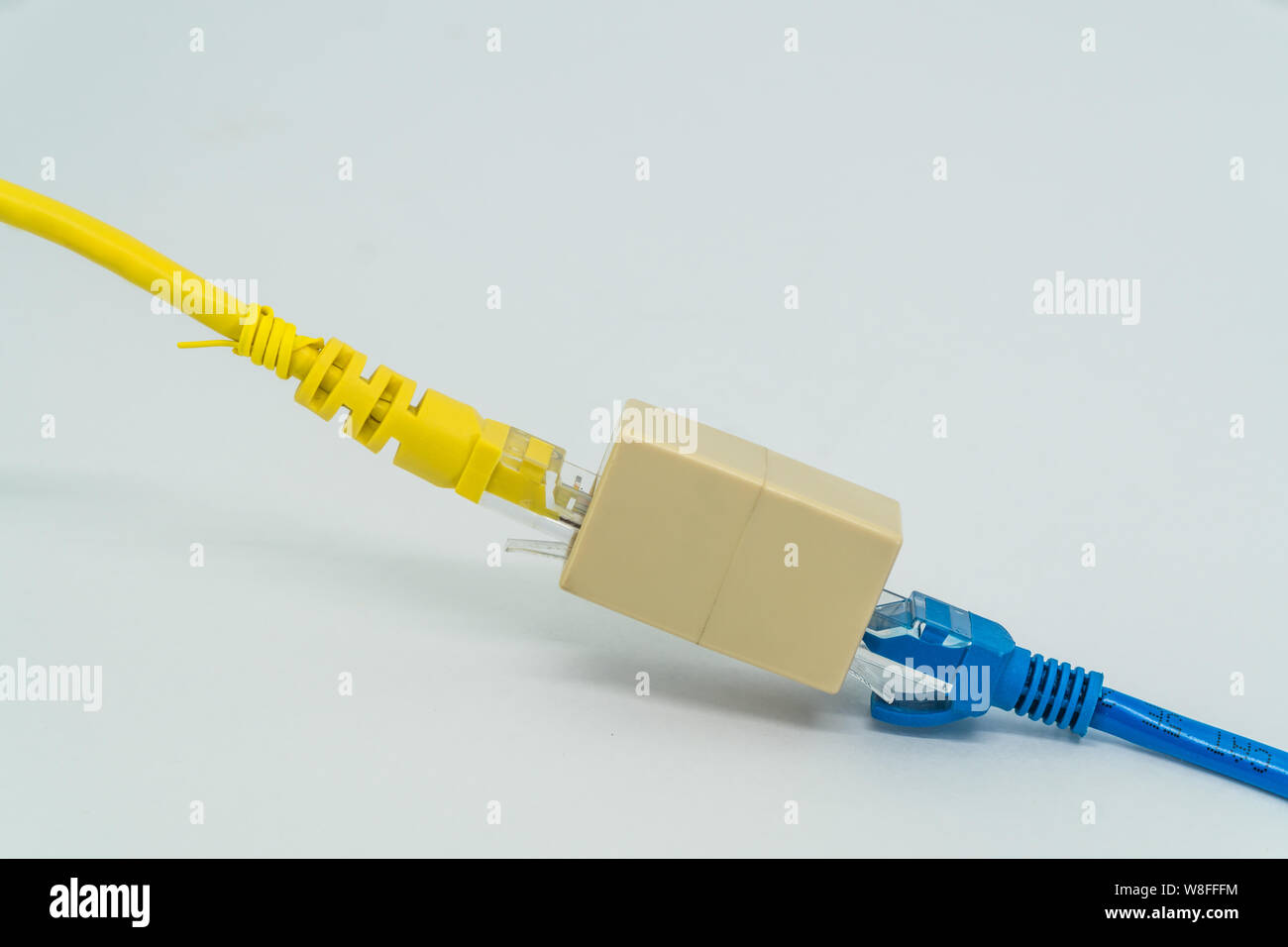 Blue and Yellow Cat5e cables plug RJ45 cable extender on a