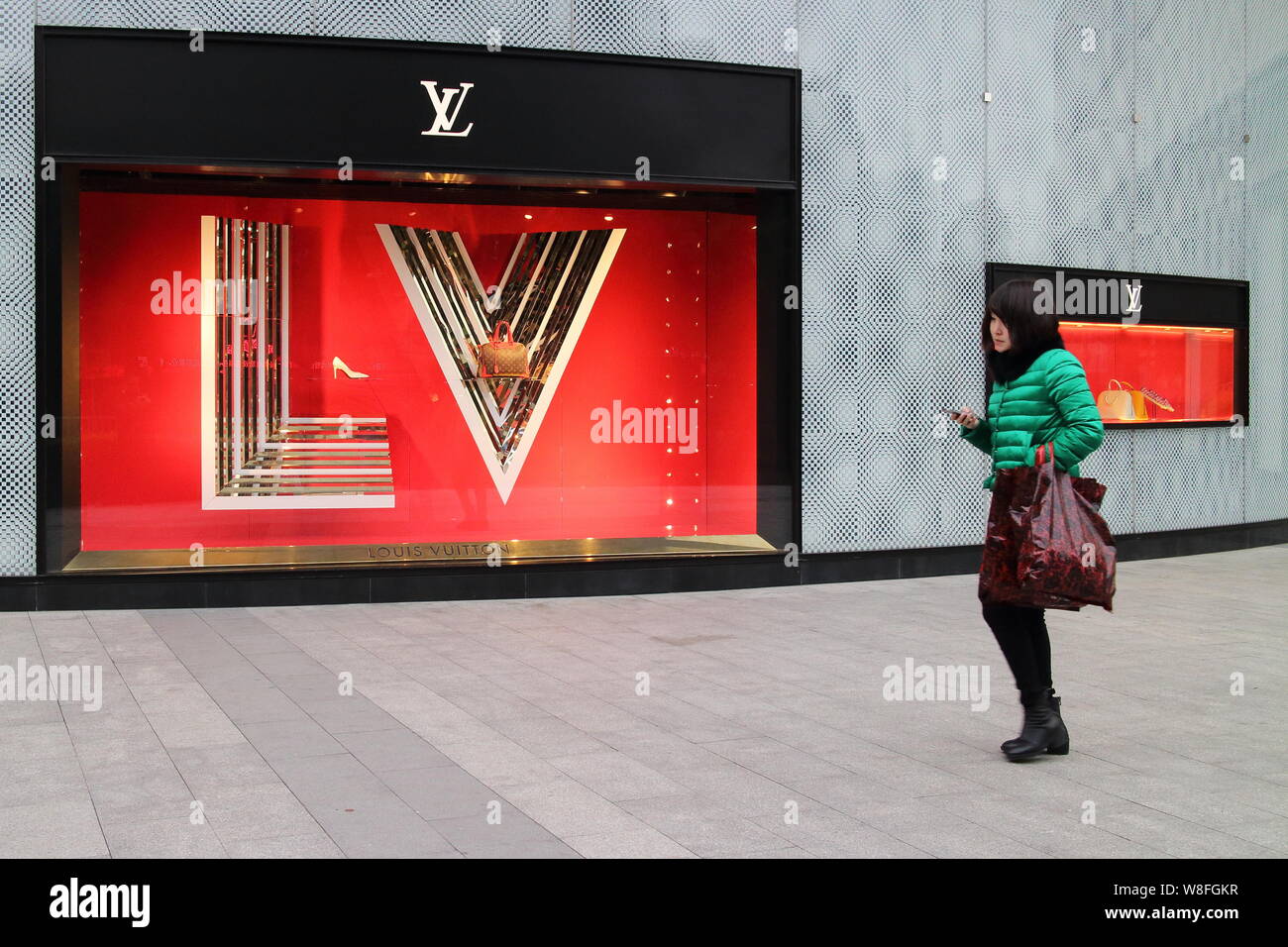 FILE--A pedestrian walks past a Louis Vuitton (LV) boutique of LVMH Moet Hennessy  Louis Vuitton SA in Fuzhou city, southeast China's Fujian province Stock  Photo - Alamy
