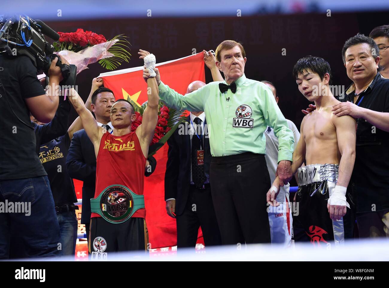 Xiong Chaozhong of China, left, poses after defeating Hiroya Yamamoto