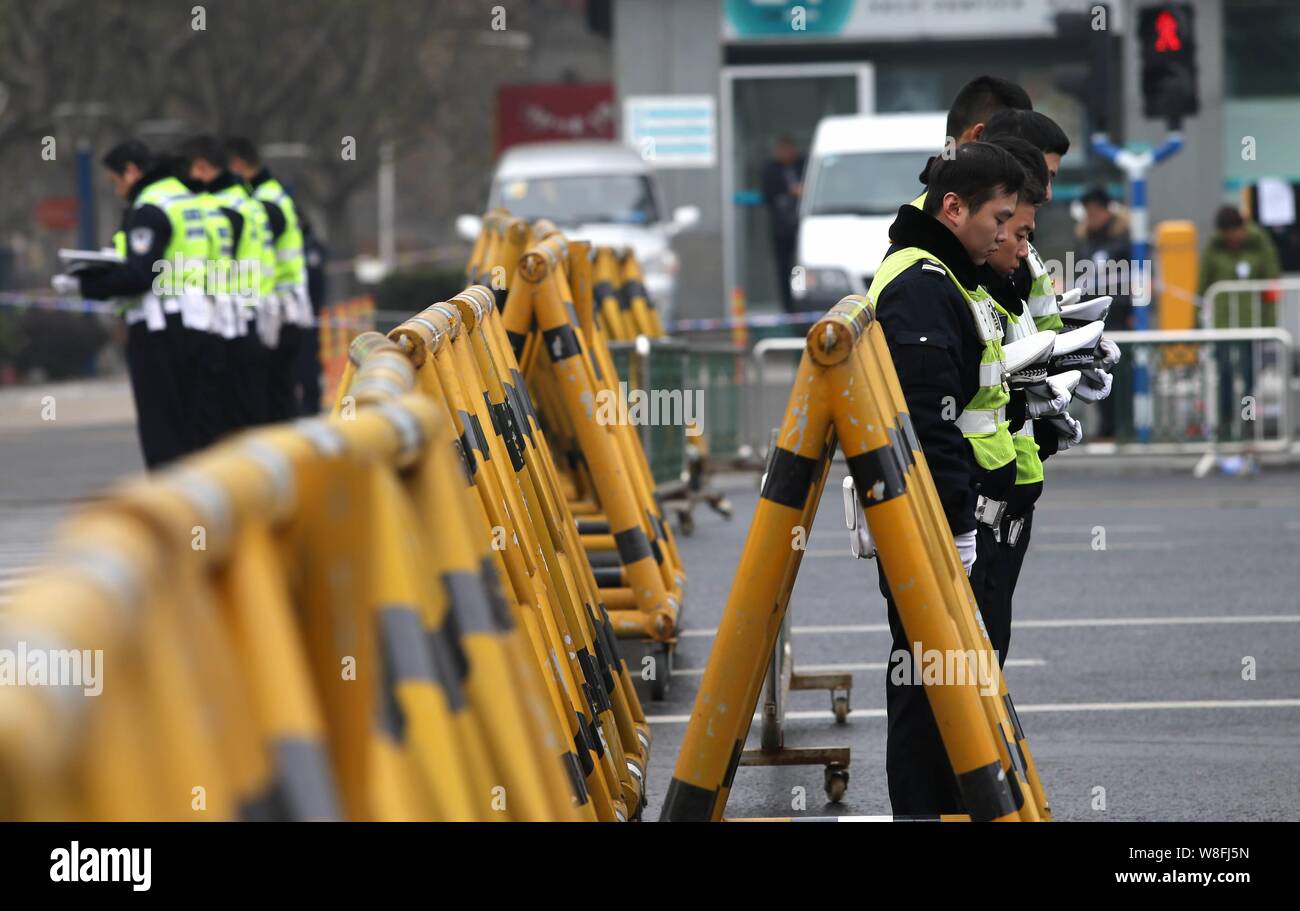 Chinese police officers observe a moment of silence to mour for the victims of the Nanjing Massacre on a road in Nanjing city, east China's Jiangsu pr Stock Photo