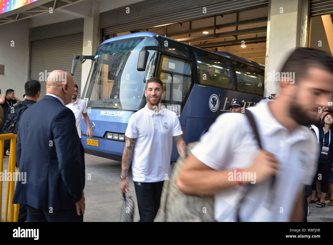 Sergio Ramos, center, and teammates of Real Madrid arrive at the Shanghai Stadium before a friendly soccer match against AC Milan in Shanghai, China, Stock Photo