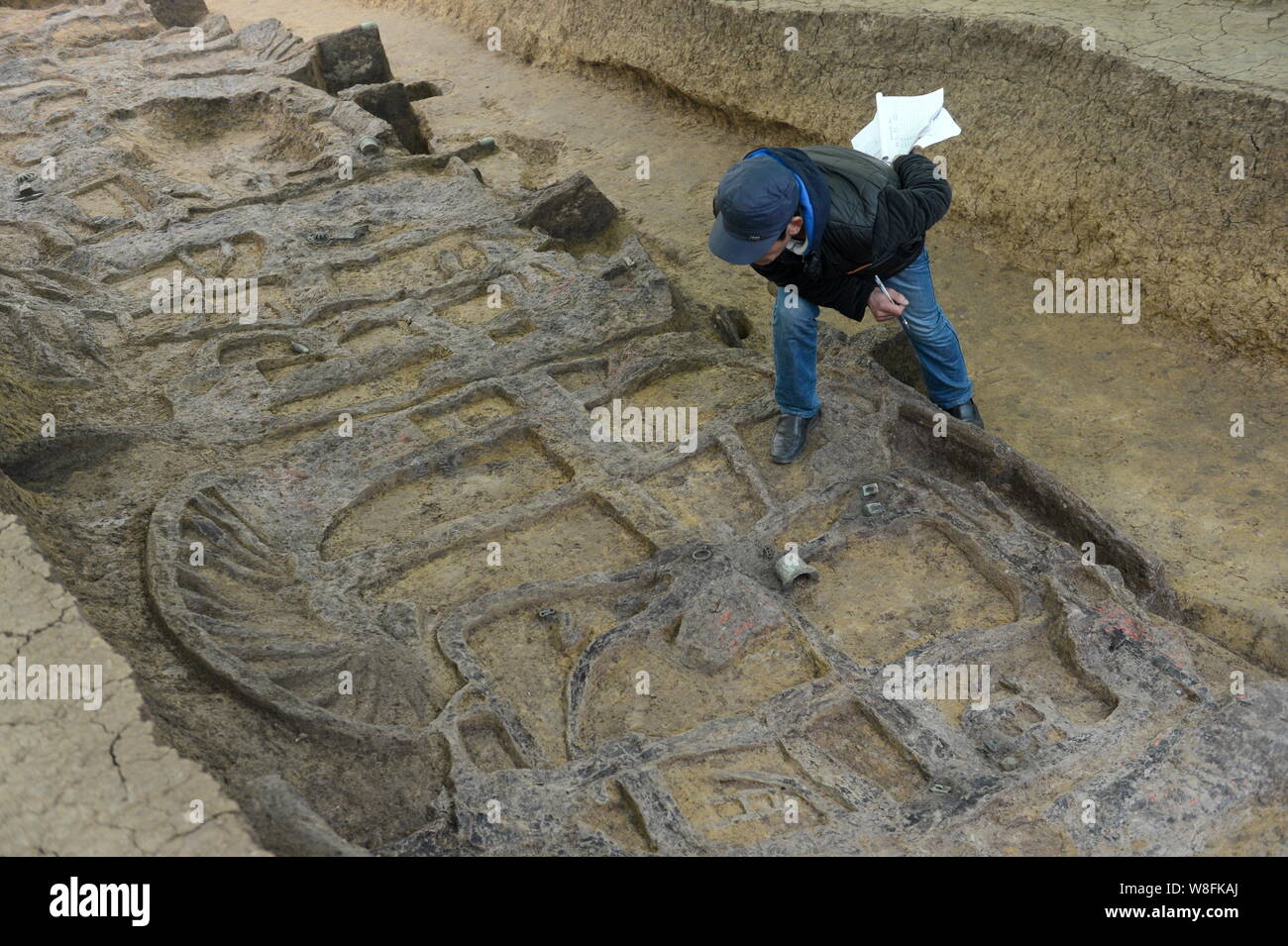 An archaeologist surveys the site of the earliest garage in China near a tomb dating back to either the Western Zhou Dynasty (1046 B.C.-771 B.C.) or t Stock Photo