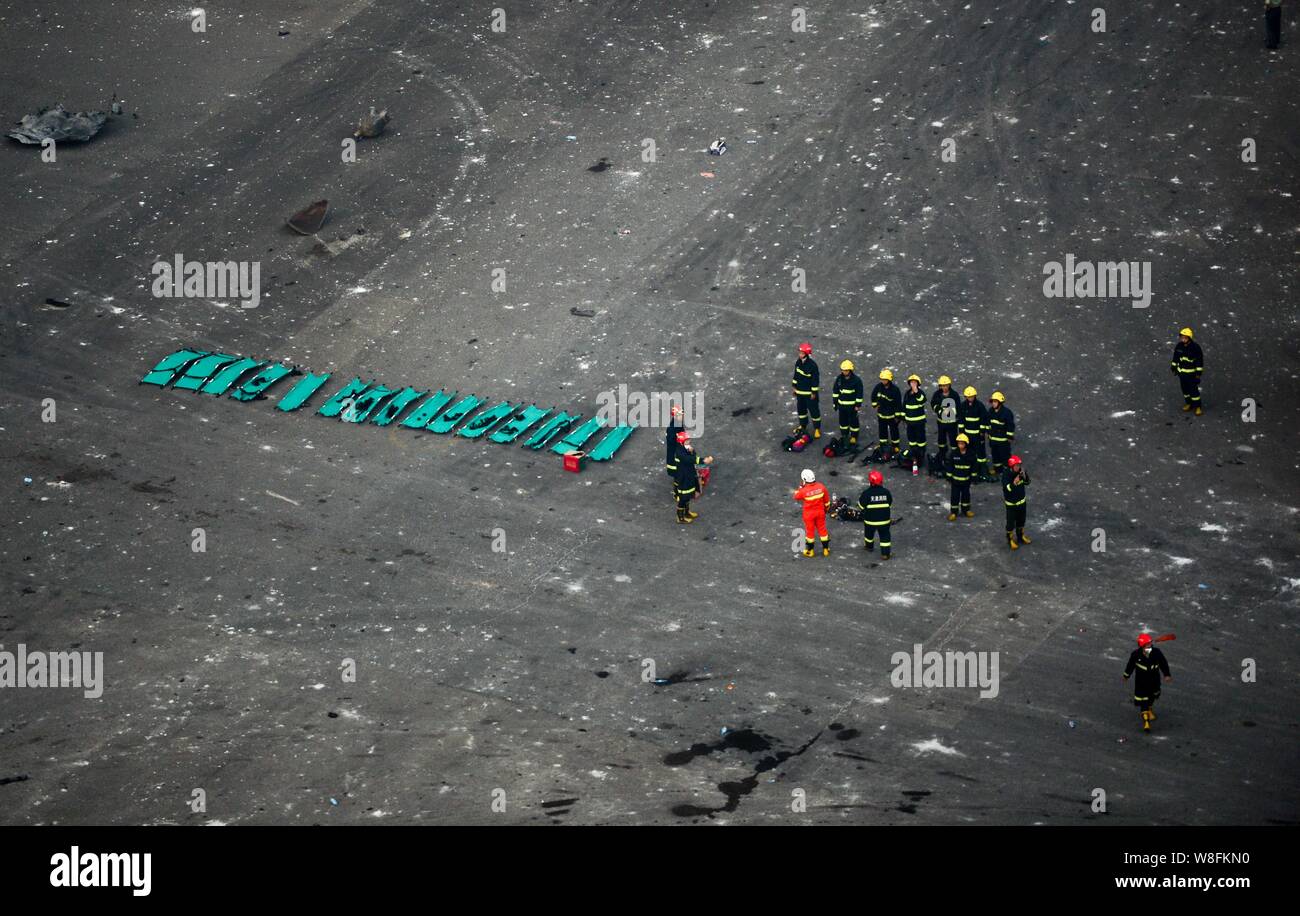 Chinese firefighters prepare for rescue missions at the blast site after the deadly explosions in Binhai New Area in Tianjin, China, 13 August 2015. Stock Photo