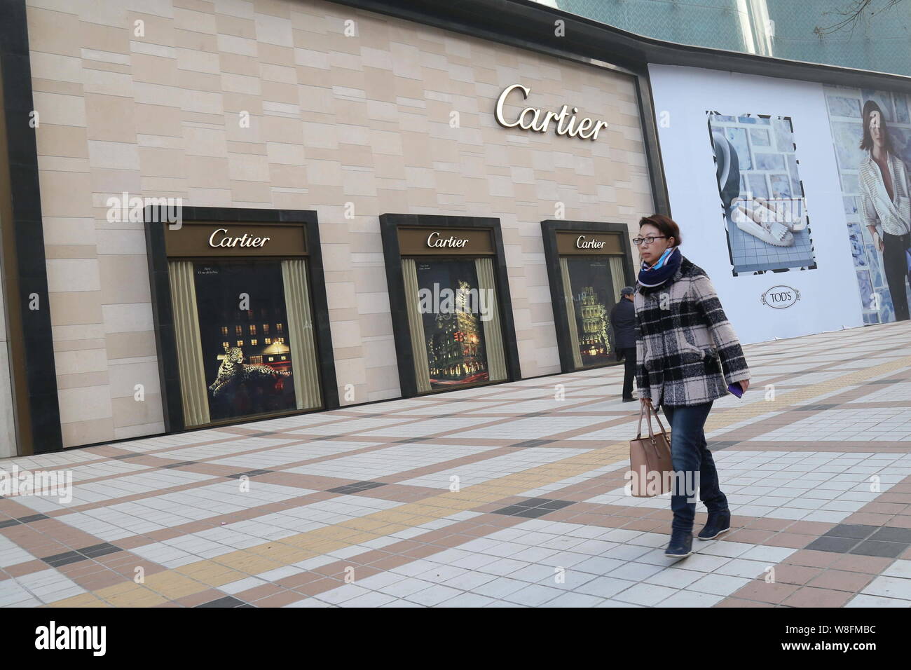 pedestrian walks past the Cartier store 
