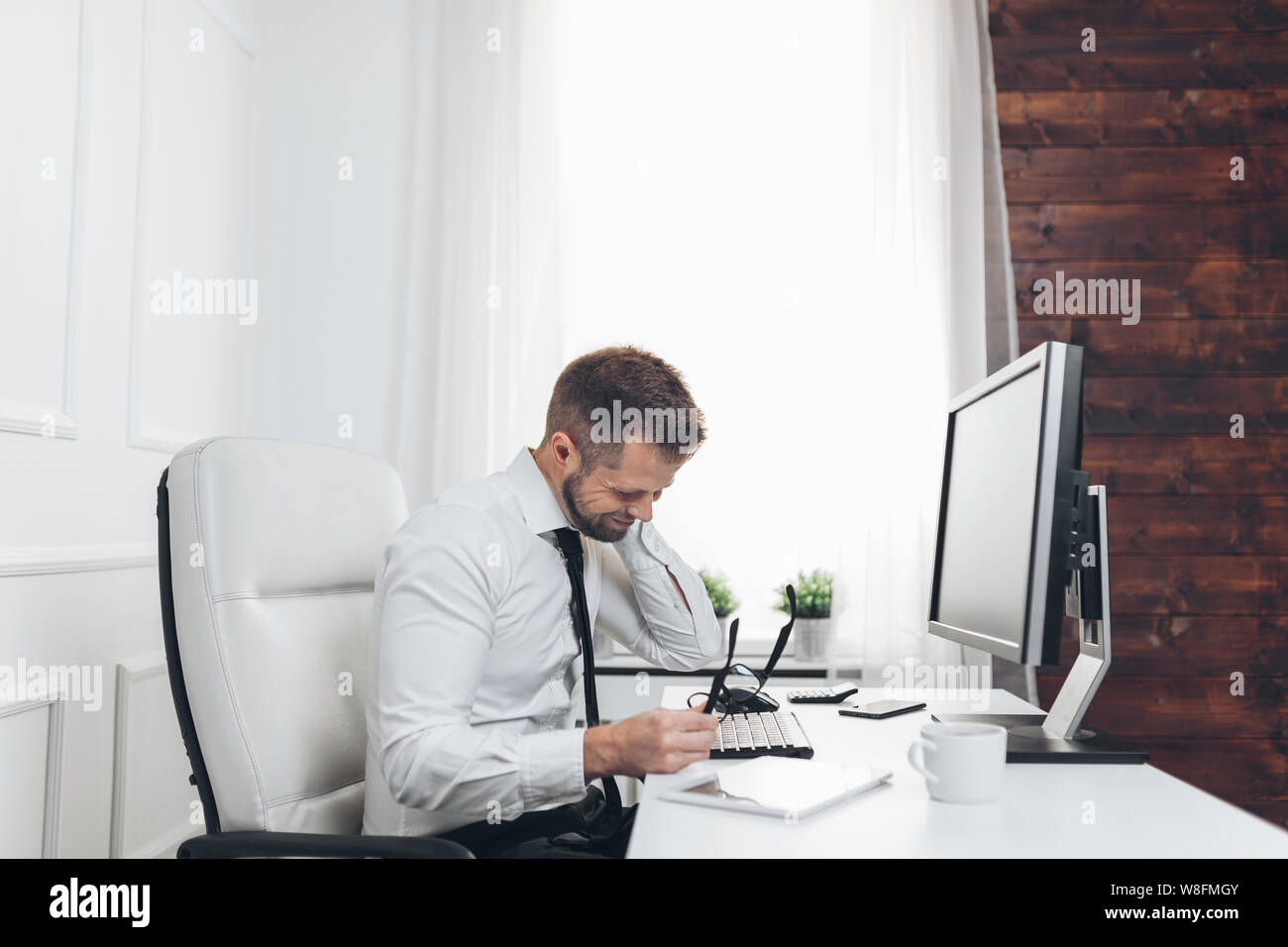 Office Worker With Back Pain From Sitting At Desk All Day Stock