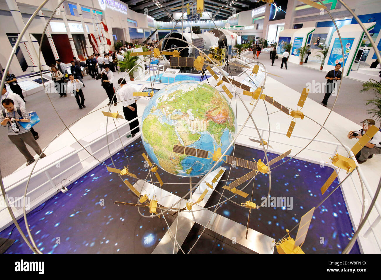 --FILE--Visitors look at a model of the Beidou navigation satellite system on display at the 9th China International Aviation and Aerospace Exhibition Stock Photo