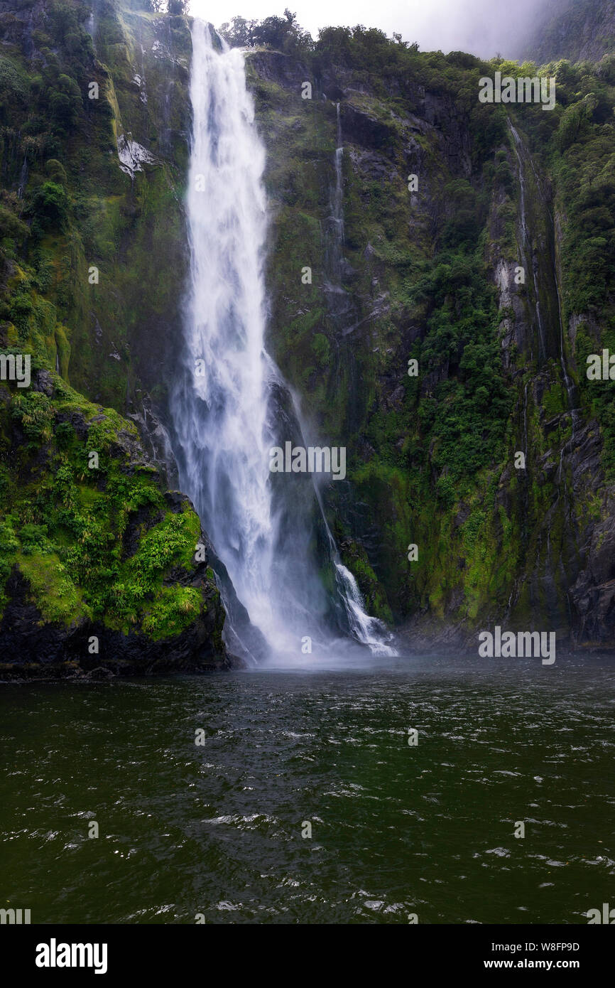 Stirling Falls plunging beneath its hanging valley into the Sound Stock Photo