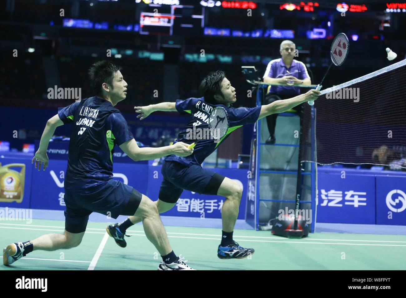 Kenichi Hayakawa, front, and Hiroyuki Endo of Japan compete against Kim Astrup and Mads Pieler