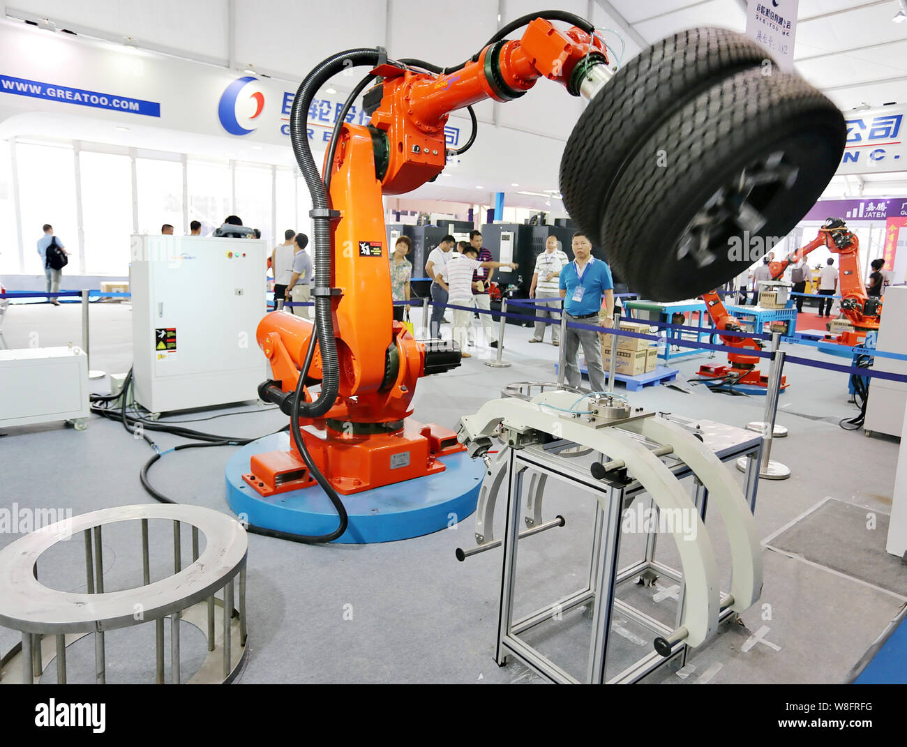 FILE--A robot arm demonstrates lifting tires at an expo in Foshan city,  south China's Guangdong province, 11 September 2015. For decades, manufactu  Stock Photo - Alamy