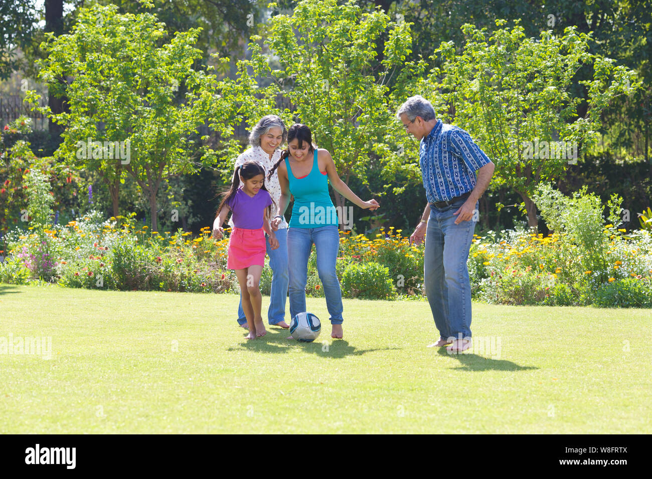 Family playing football in lawn Stock Photo - Alamy