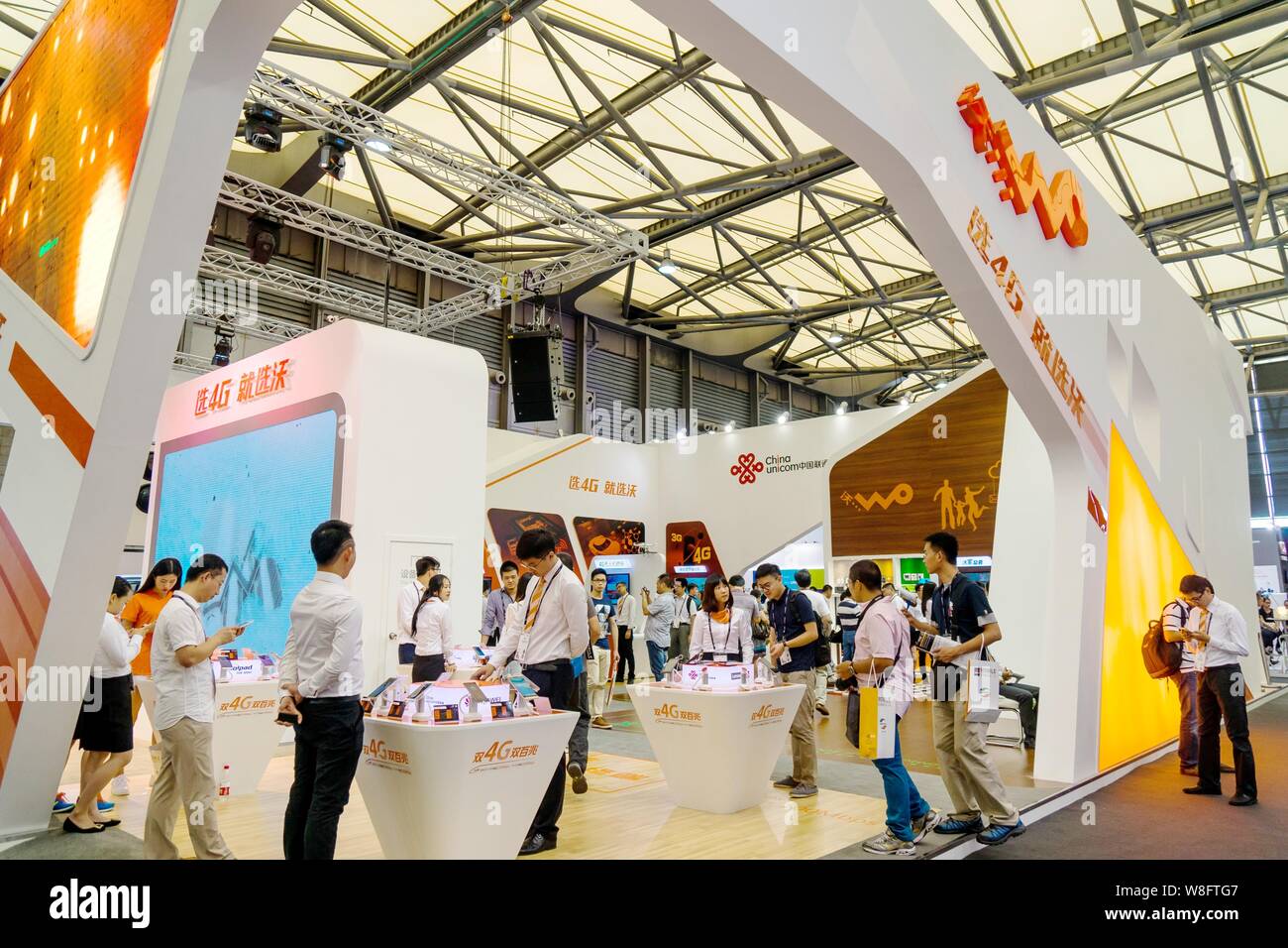 People visit the stand of China Unicom during the GSMA Mobile World Congress 2015 in Shanghai, China, 15 July 2015. Stock Photo