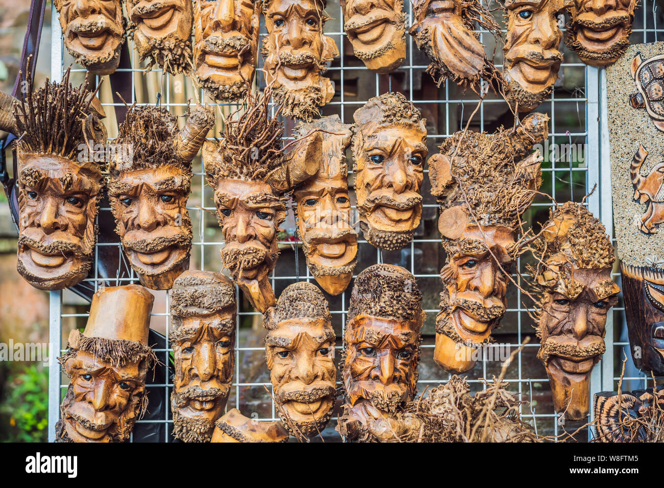 Typical souvenir shop selling souvenirs and handicrafts of Bali at the famous Ubud Market, Indonesia. Balinese market. Souvenirs of wood and crafts of Stock Photo