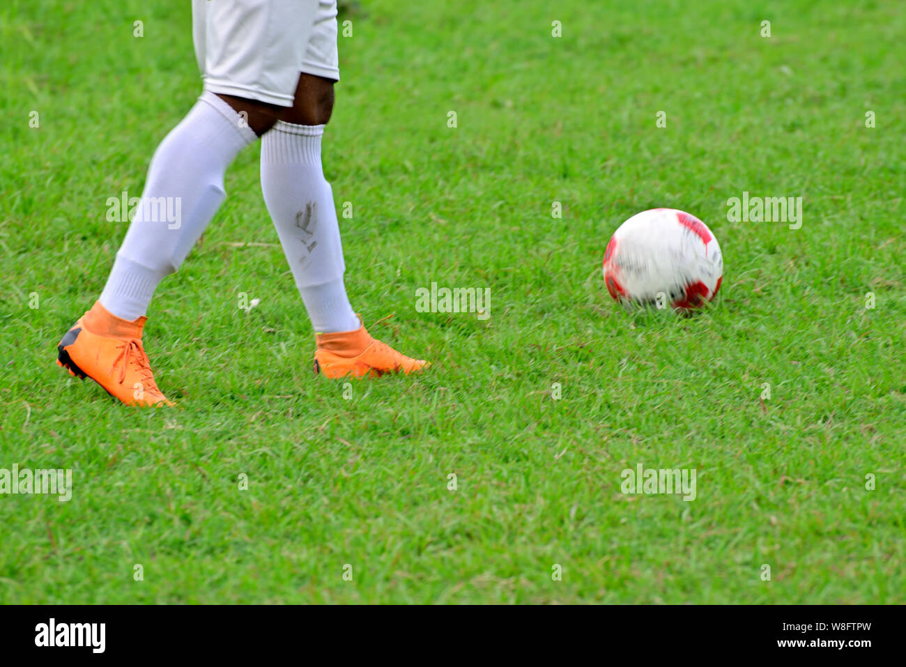 Soccer player is running to kick soccer ball Stock Photo Alamy
