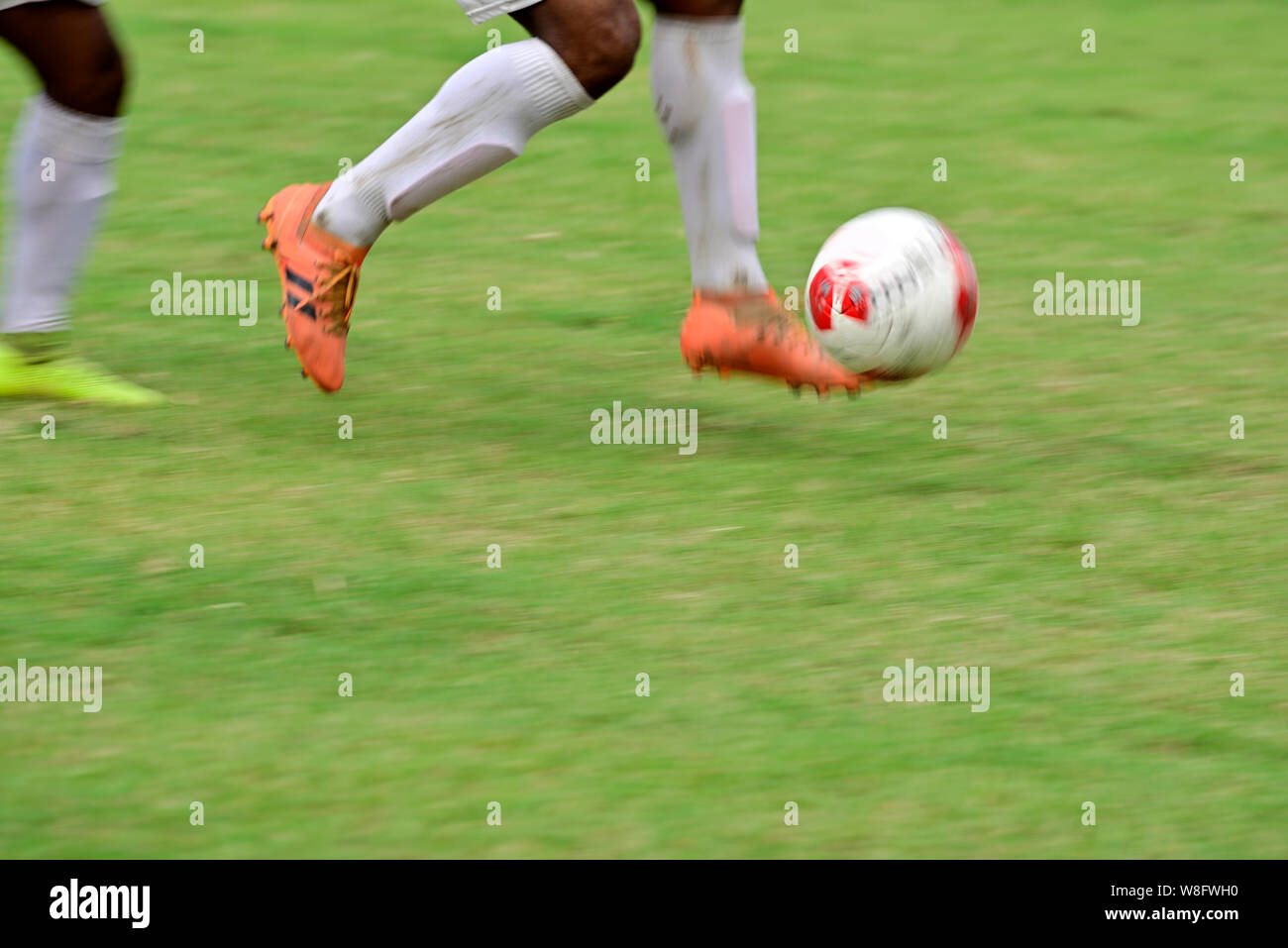 Soccer player is running to kick soccer ball Stock Photo Alamy