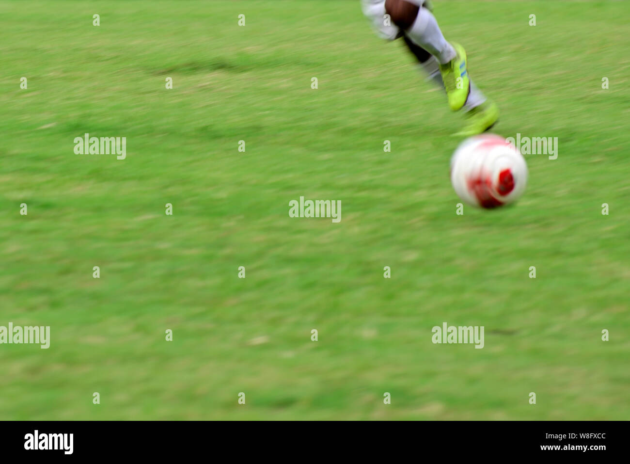 Soccer player is running to kick soccer ball Stock Photo Alamy