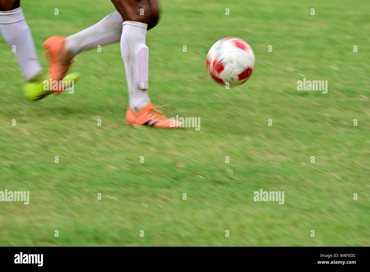 Soccer player is running to kick soccer ball Stock Photo Alamy