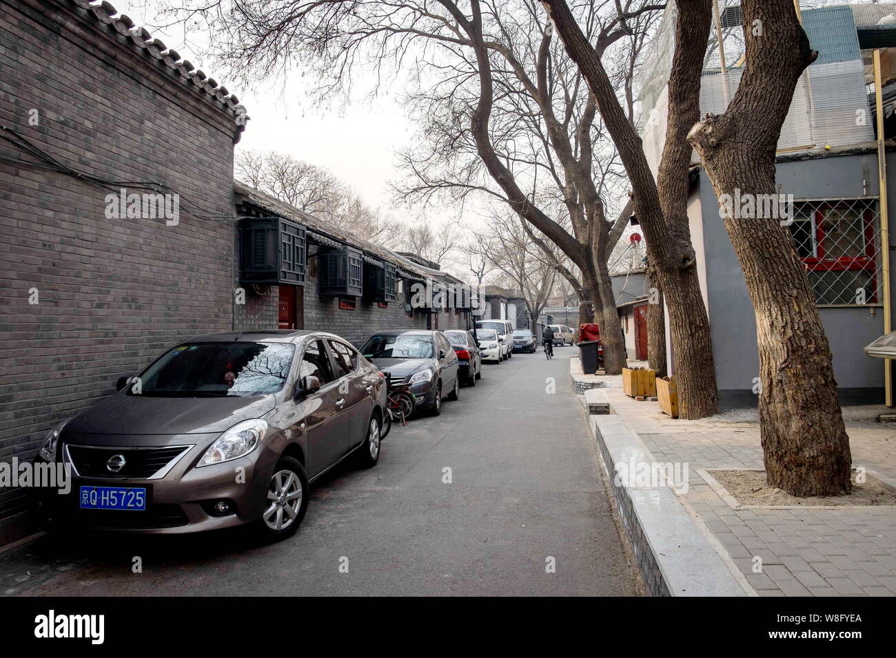 --FILE--Cars are parked along an alley in a hutong in Beijing, China, 2 February 2015.   Beijing plans to require local car buyers to show proof they Stock Photo