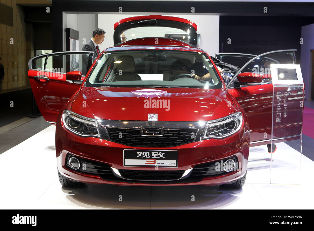 --FILE--A visitor tries out a Qoros 3 during an auto show in Nanjing city, east Chinas Jiangsu province, 3 October 2014.     The former China head of Stock Photo