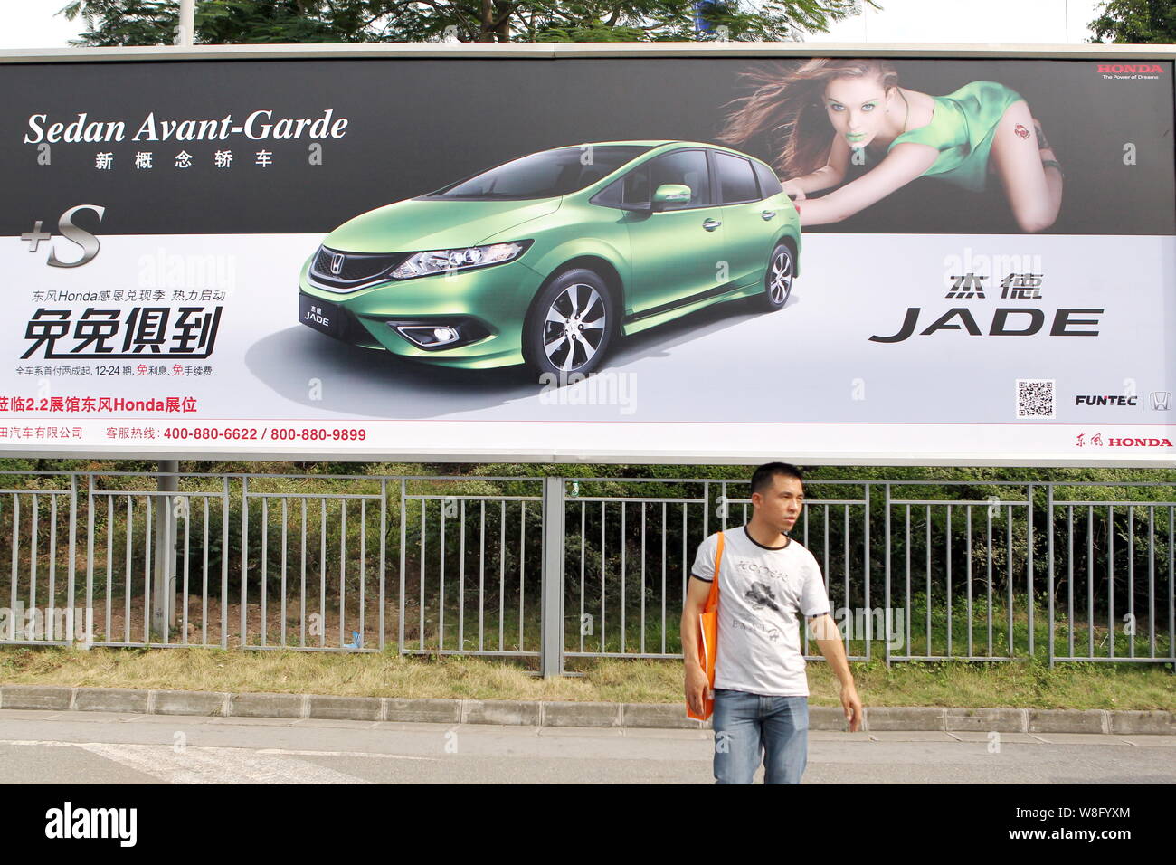 File A Visitor Walks Past An Advertisement For Honda Jade During The 11th China Guangzhou International Automobile Exhibition Known As Auto Guan Stock Photo Alamy