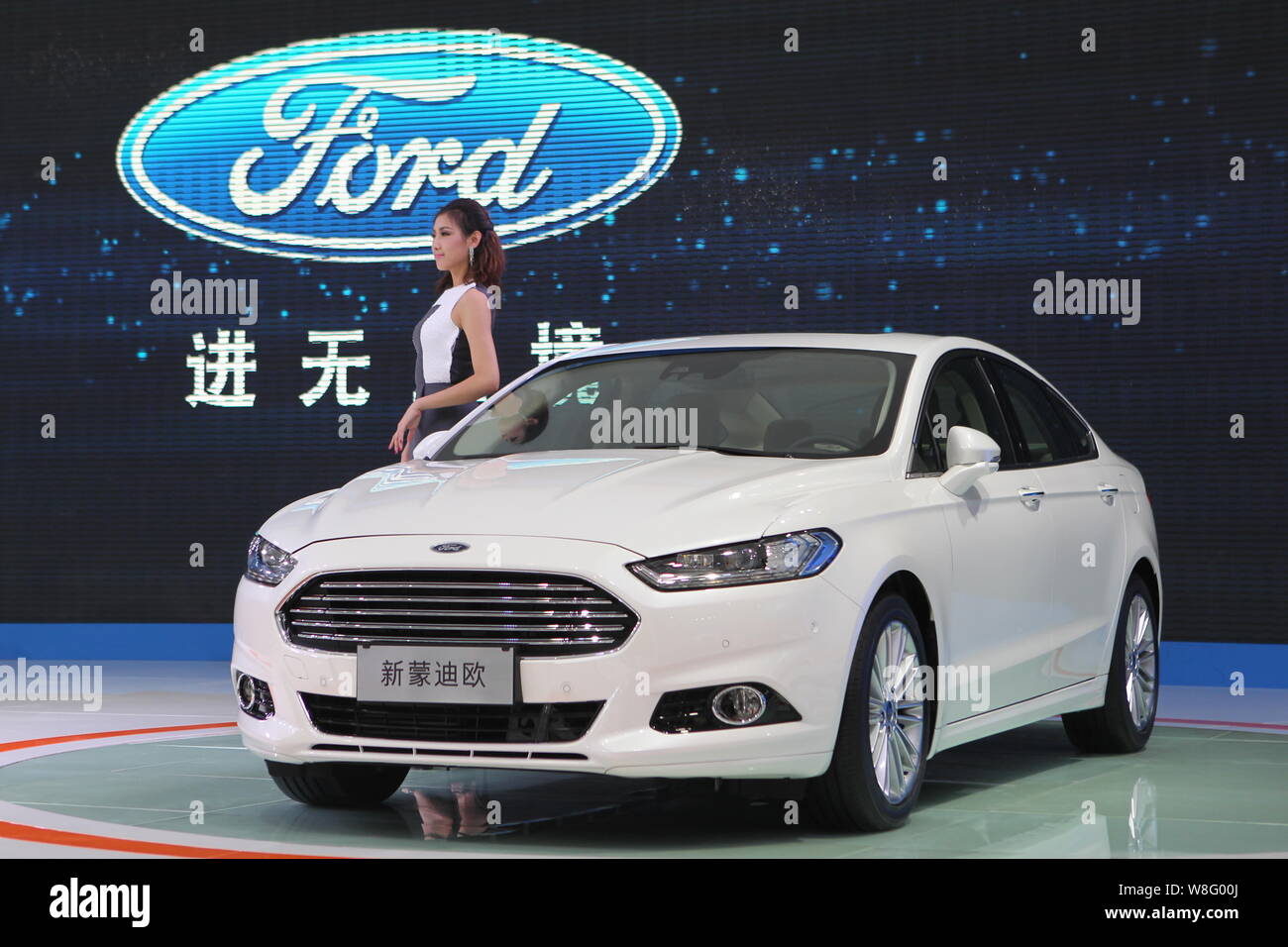 --FILE--A model poses with a Ford New Mondeo during the 11th China (Guangzhou) International Automobile Exhibition, known as Auto Guangzhou 2013, in G Stock Photo